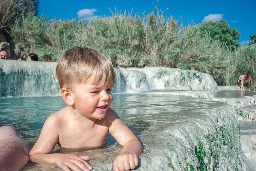 Kids swimming at Saturnia Hot Springs