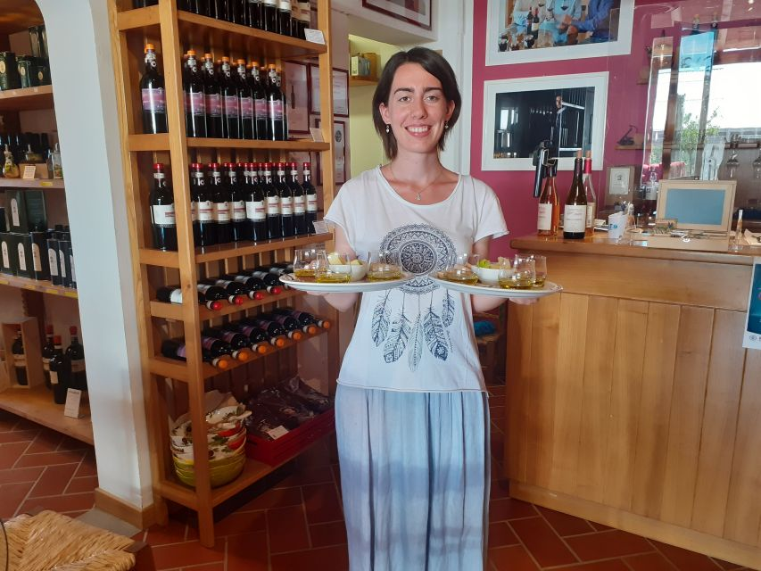 Best things to do in Tuscany - a woman holding plates of olive oil for an olive oil tasting tour in tuscany